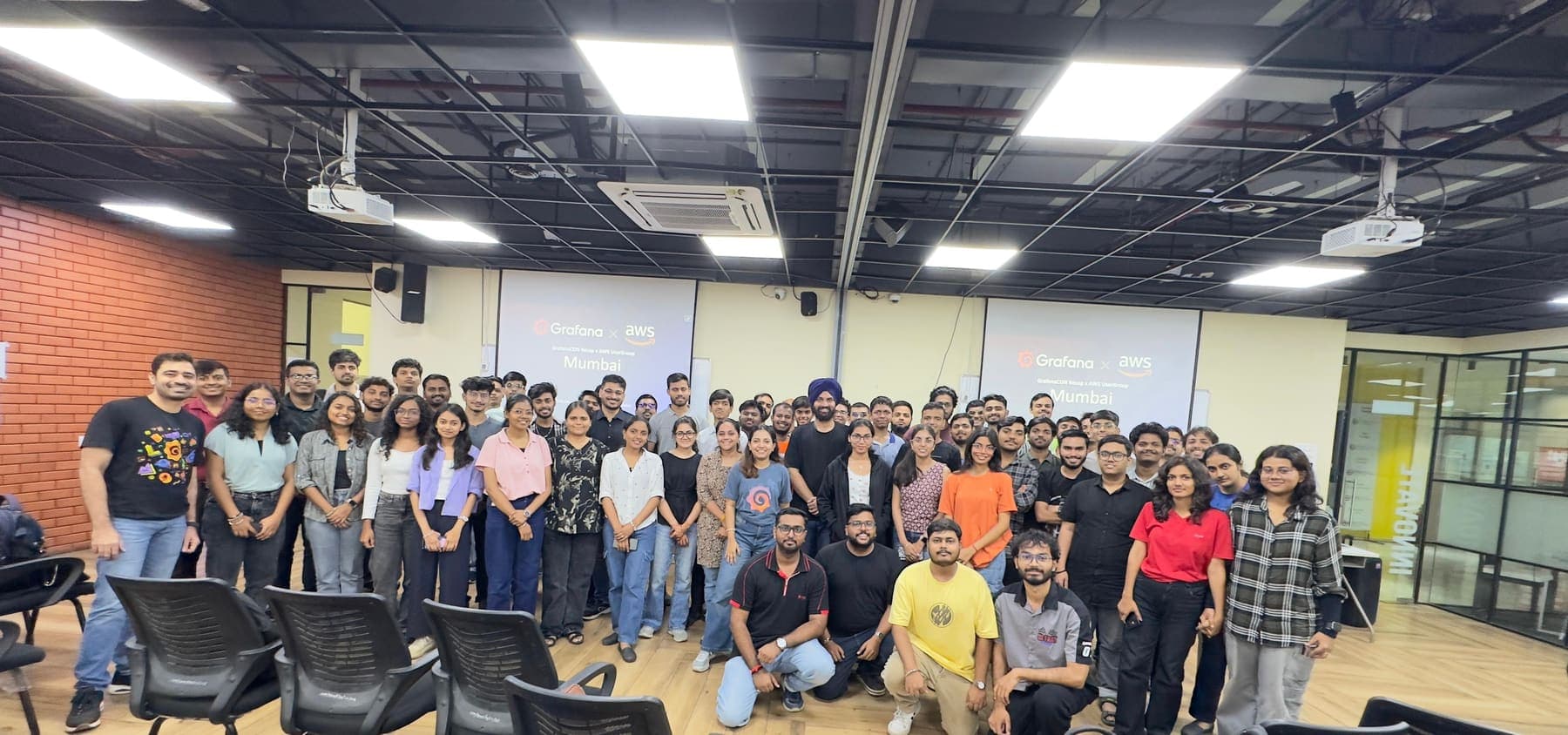 Grafana × AWS User Group, Mumbai. A joint meetup with a full room for the group photo.